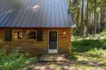 Escape to this charming log cabin nestled in a serene forest setting.