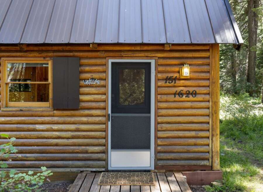 Experience rustic charm in this cozy log cabin, perfect for a secluded getaway.