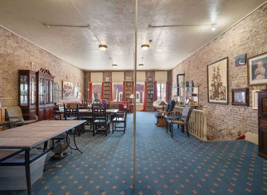 Discover this expansive loft-style living space featuring exposed brick walls and a large, open floor plan perfect for entertaining.