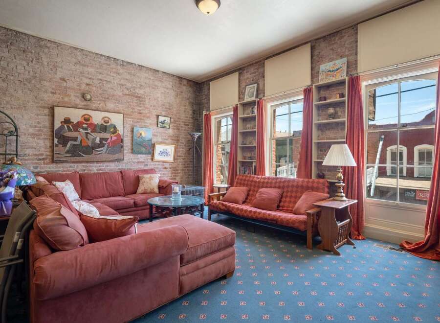 Experience urban living in this charming loft-style apartment featuring exposed brick walls and large windows that flood the space with natural light.