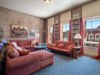 Experience urban living in this charming loft-style apartment featuring exposed brick walls and large windows that flood the space with natural light.