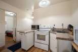 This charming kitchen features a full-sized electric range and a compact toaster oven, perfect for preparing meals.
