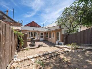 Enjoy outdoor living in this charming backyard featuring a spacious deck perfect for entertaining and a grill ready for summer cookouts.