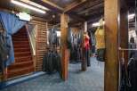 Discover a unique retail space with a rustic, log-cabin aesthetic, perfect for a motorcycle apparel store.
