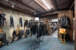 Explore this unique retail space, perfect for a motorcycle apparel store, featuring a rustic wooden ceiling and exposed beams.