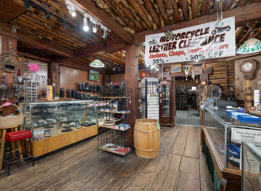 Explore a unique retail space with a rustic, log-cabin aesthetic, perfect for a motorcycle enthusiast's dream store.