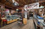 Explore a unique retail space with a rustic, log-cabin aesthetic, perfect for a motorcycle enthusiast's dream store.