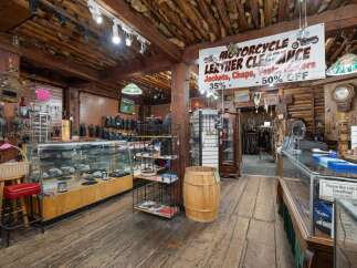 Explore a unique retail space with a rustic, log-cabin aesthetic, perfect for a motorcycle enthusiast's dream store.
