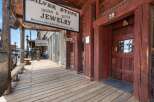 Step back in time with this historic storefront, featuring the 'Silver Stop' Indian & Silver Jewelry shop and a classic saloon.