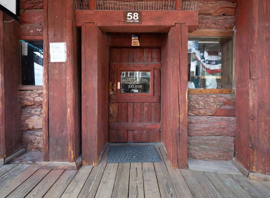 Step into a piece of history at this rustic saloon, featuring a classic wooden facade and a welcoming entrance.