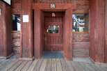 Step into a piece of history at this rustic saloon, featuring a classic wooden facade and a welcoming entrance.