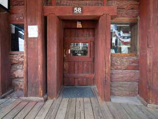 Step into a piece of history at this rustic saloon, featuring a classic wooden facade and a welcoming entrance.