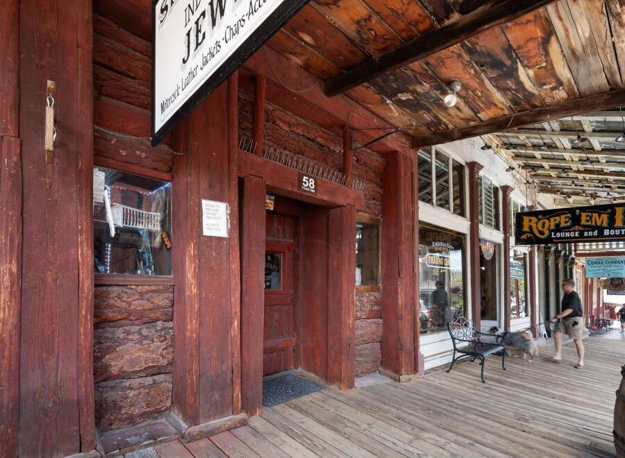 Step back in time with this historic property featuring rustic log construction and a charming wooden boardwalk.