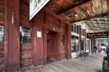Step back in time with this historic property featuring rustic log construction and a charming wooden boardwalk.