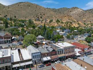 Explore this historic Western town nestled in a picturesque mountain landscape.