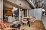 Enjoy breathtaking mountain views from this stunning modern chalet's expansive outdoor deck.