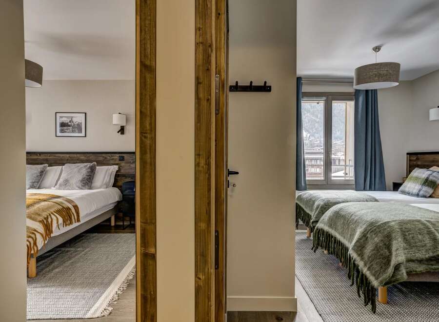 Experience comfort and style in this charming hotel room, featuring two distinct sleeping areas.