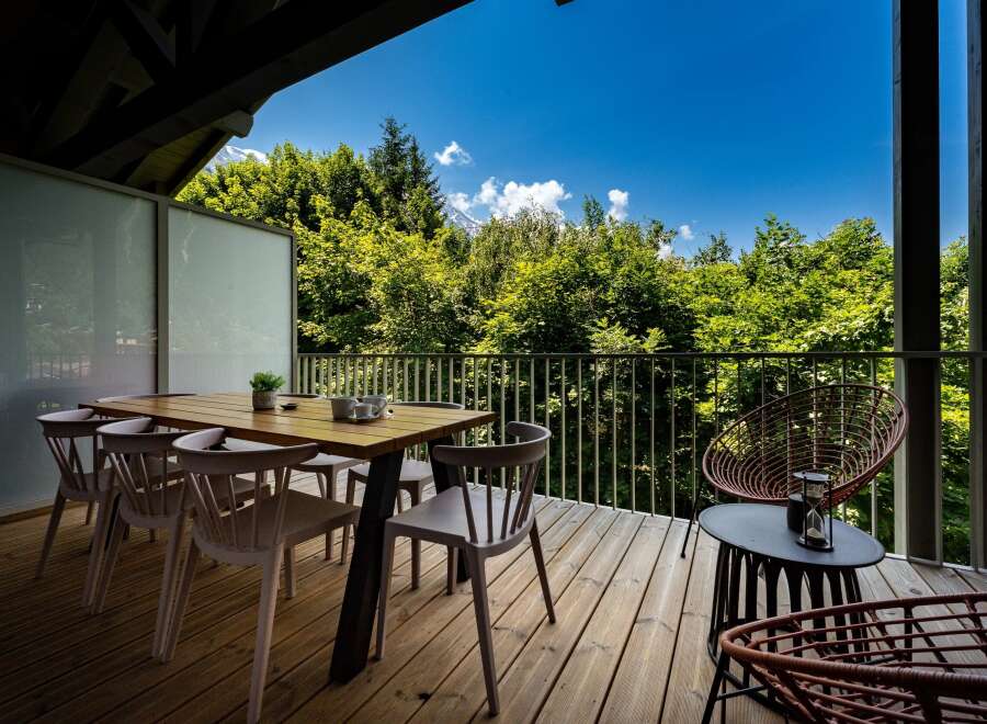 Enjoy breathtaking mountain views from this stunning balcony, perfect for al fresco dining or morning coffee.