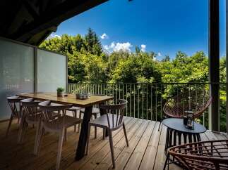 Enjoy breathtaking mountain views from this stunning balcony, perfect for al fresco dining or morning coffee.