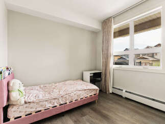 Discover this charming bedroom featuring a comfortable pink bed with a whimsical unicorn-themed comforter, perfect for a child's sanctuary.