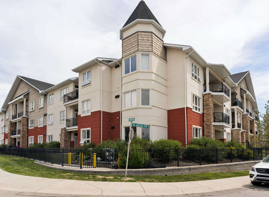 Discover modern living in this stunning apartment complex, featuring a charming turret and elegant stone accents.