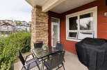 Enjoy outdoor living on this charming patio featuring a glass-top dining table with four chairs, perfect for al fresco meals.
