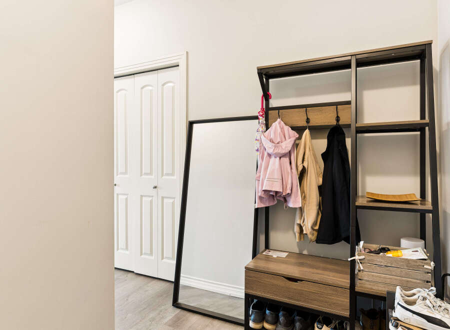Welcome guests into a stylish entryway featuring a modern coat rack with ample storage and hanging space for jackets and accessories.
