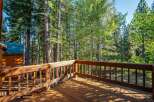 Enjoy the serene mountain setting from this charming wooden deck, perfect for outdoor relaxation and entertaining.