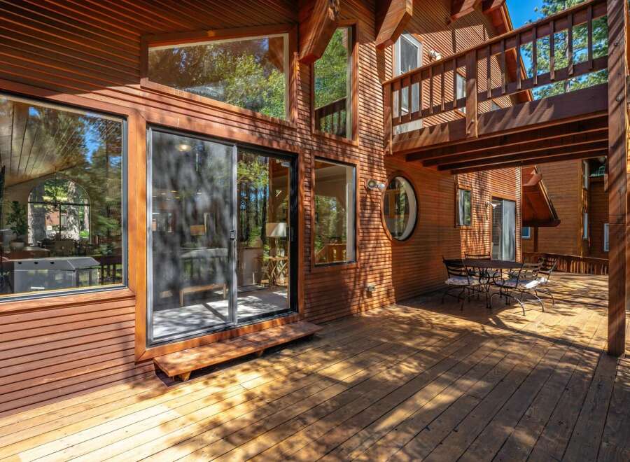 Experience the ultimate indoor-outdoor living with this stunning wooden deck, perfect for entertaining or relaxing amidst nature.