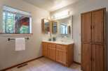 This bathroom features a spacious vanity with ample storage and a large mirror, perfect for your morning routine.