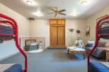 This versatile room features a playful teepee and bunk beds, perfect for a kids' play area or a unique guest room.