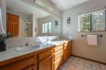 This bright and airy bathroom features a spacious double vanity with ample counter space and storage.