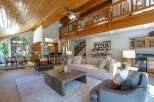 Experience the warmth of this stunning home featuring a vaulted wood-paneled ceiling and an open-concept living area.