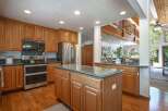 This spacious kitchen boasts beautiful oak cabinetry and granite countertops, perfect for any home chef.