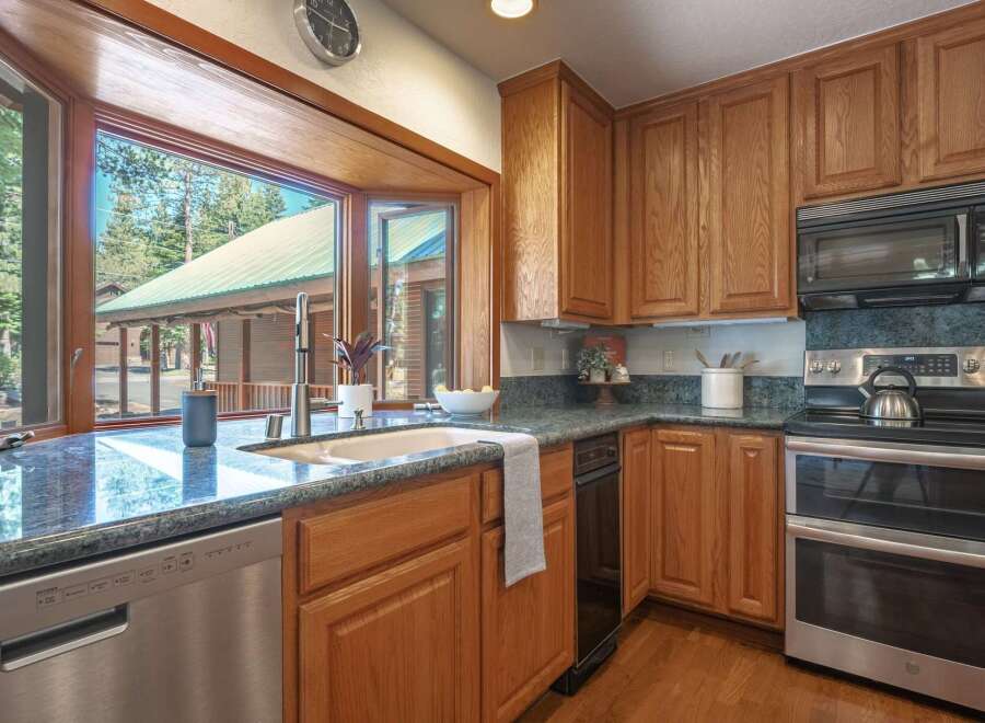 This charming kitchen boasts beautiful oak cabinetry and granite countertops, perfect for any home chef.