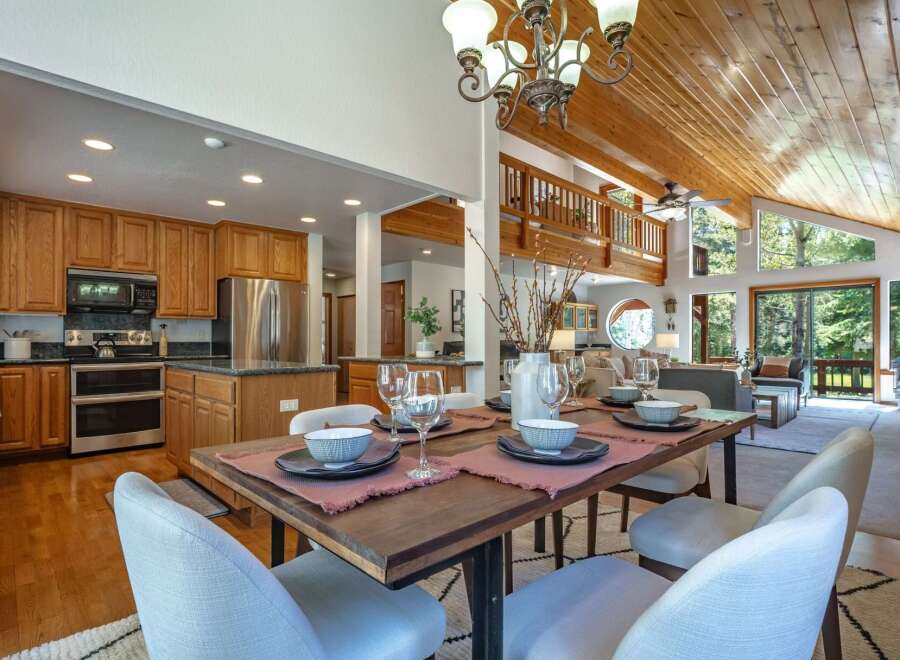 Experience open-concept living in this stunning home, featuring a gourmet kitchen with ample cabinet space and stainless steel appliances, seamlessly flowing into a spacious dining area perfect for entertaining.