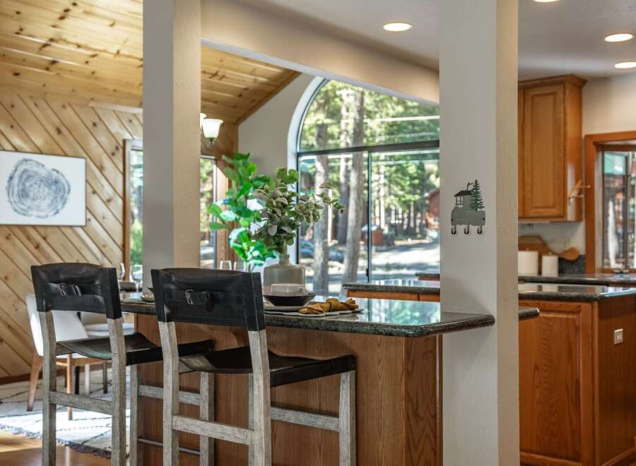 Experience the perfect blend of rustic charm and modern comfort in this inviting kitchen and dining area.