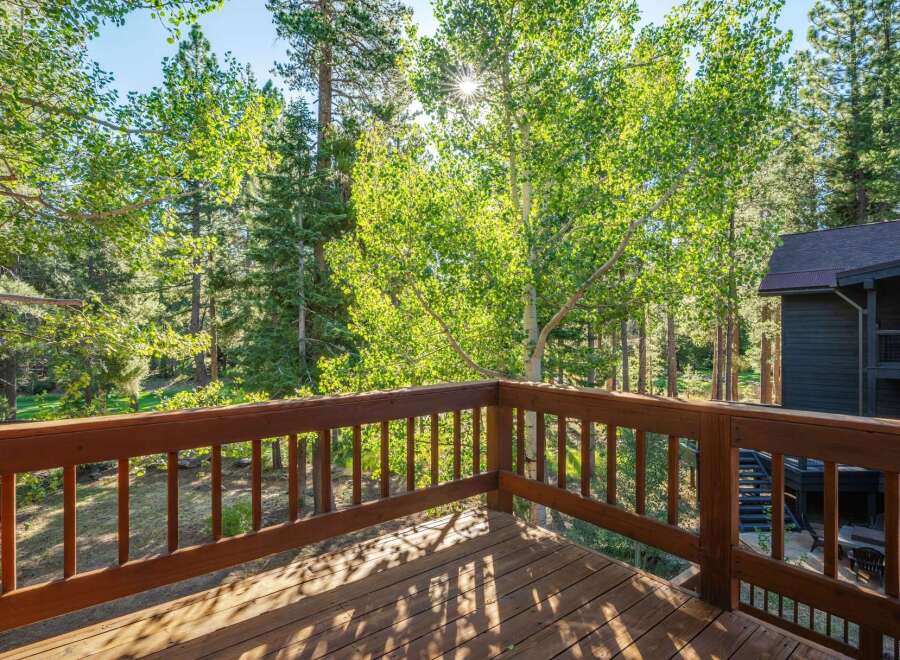Enjoy the serene mountain lifestyle from this charming deck, perfect for morning coffee or evening relaxation amidst the towering trees.