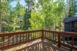 Enjoy the serene mountain lifestyle from this charming deck, perfect for morning coffee or evening relaxation amidst the towering trees.