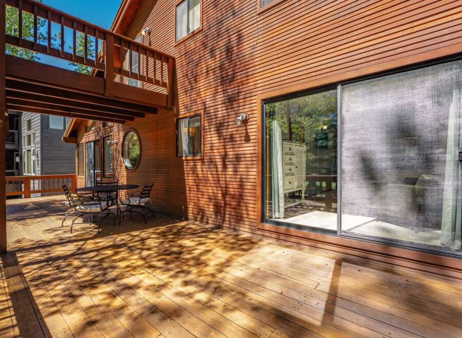 Enjoy outdoor living on this expansive wooden deck, perfect for entertaining or relaxing.