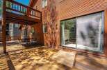 Enjoy outdoor living on this expansive wooden deck, perfect for entertaining or relaxing.