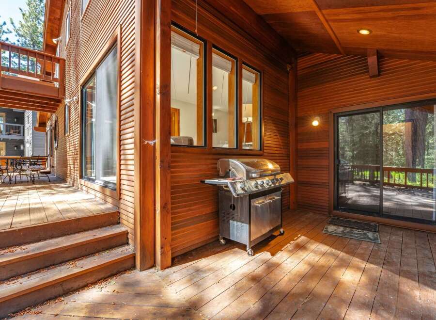 Enjoy outdoor living on this expansive wooden deck, perfect for entertaining guests.