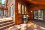 Enjoy outdoor living on this expansive wooden deck, perfect for entertaining guests.