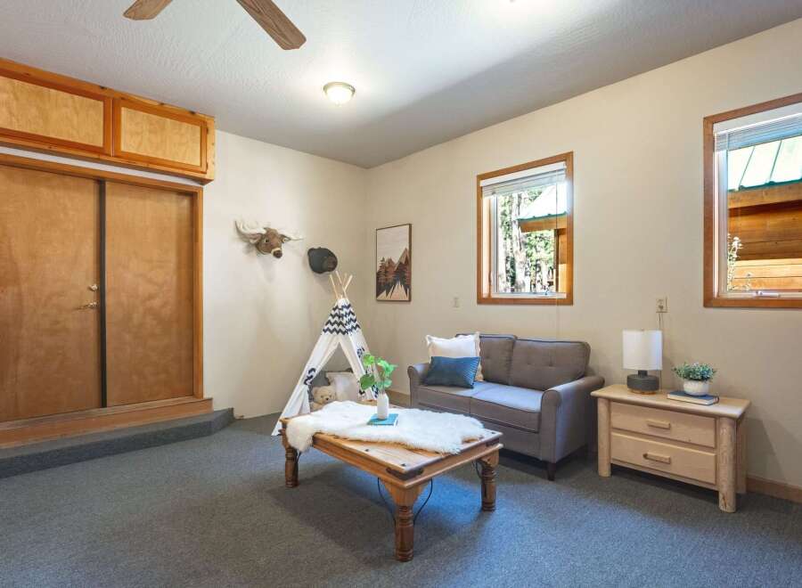 Step into a cozy living space featuring a charming teepee and plush seating, perfect for relaxation.