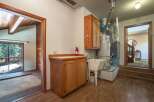 Discover practical living with this laundry area featuring a utility sink and ample cabinet space for storage.