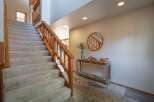Ascend to the upper level via a plush carpeted staircase, complemented by a warm wooden banister.