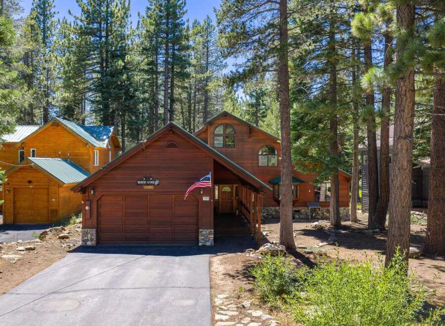 Nestled amongst tall pine trees, this charming wooden home offers a serene mountain retreat.