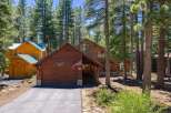 Nestled amongst tall pine trees, this charming wooden home offers a serene mountain retreat.