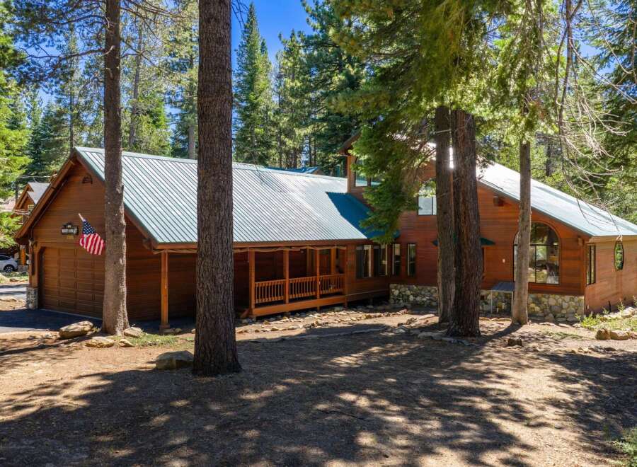 Nestled amidst towering pine trees, this charming wooden cabin offers a serene mountain retreat.