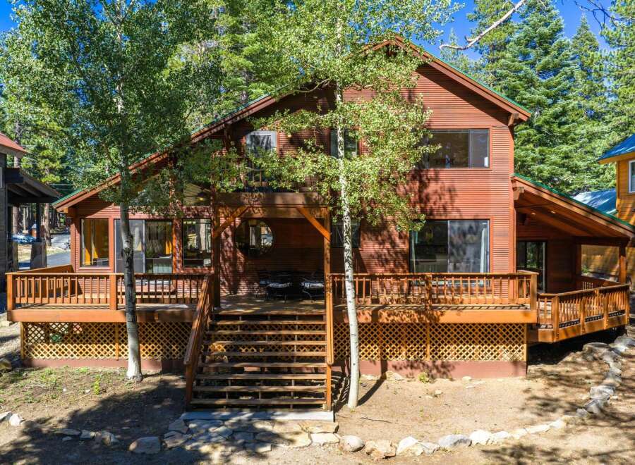 Experience rustic charm in this beautiful wooden home, nestled amongst tall trees.